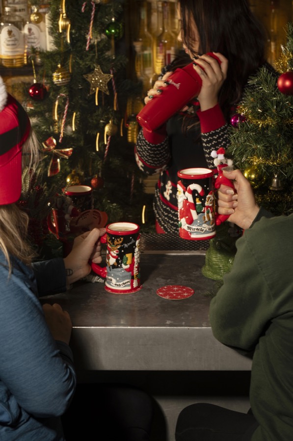 A Miracle stein being carried through a decorated bar room.