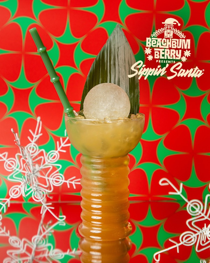A tall tropical drink with a clear white-wine ice sphere.